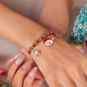 Close-up of Christmas beaded bracelet with Santa and tree charms on a model's wrist