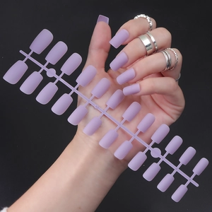 Close-up of purple matte long square press-on nails shown on model and display stand