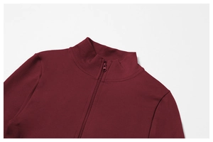 Detail of burgundy yoga jacket showing seamless stand collar and matching zipper texture