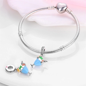 Detail of silver snake chain bracelet with heart clasp and blue enamel cocktail charms
