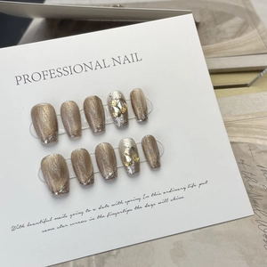 Handmade champagne cat-eye press-on nails with sparkling rhinestones and silver glitter finish