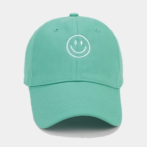 Close-up of mint green baseball cap featuring white smile embroidery on soft cotton fabric