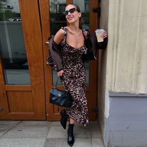 Detail of slim fit leopard print midi dress with ruffled v-neck and matching brown cardigan