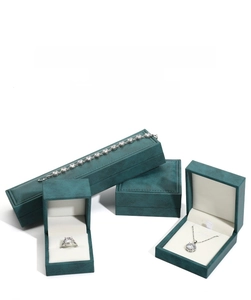 Detailed set of dark green PU leather jewelry boxes with soft cream velvet interior lining
