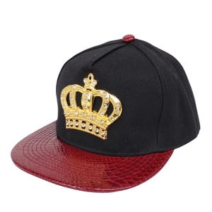 Close-up of golden crown emblem with crystals on faux crocodile leather brim hip hop cap