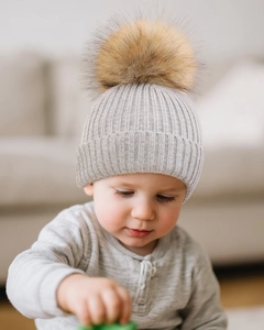 Detail of baby light grey ribbed knit beanie with a fluffy yellow faux fur pompom top