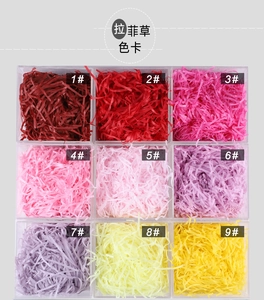 Nine colors of shredded paper fillers for gift boxes in a clear square display layout