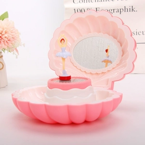 Detail of pink shell music box showing an internal mirror and rotating ballerina dancer