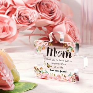 Macro shot of puzzle-shaped acrylic plaque with pink roses and Mother's Day quote