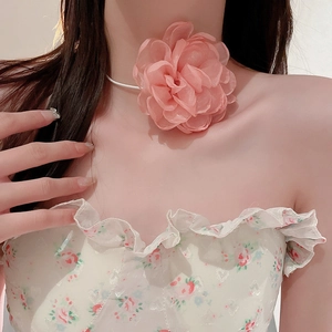 Close-up of a pink mesh floral choker featuring 3D petals and elegant white ribbons