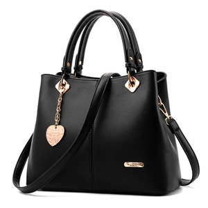 Classic black leather handbag for women with gold heart charm and detachable shoulder strap