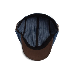 Retro denim newsboy hat with blue striped lining and brown faux leather brim details