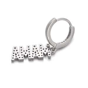 Macro detail of silver MAMA hoop earring featuring shimmering crystal-encrusted letters