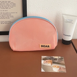 Mesh semi-circle makeup bag in pink-orange with blue zipper and leather BEAR label