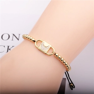 Adjustable black rope bracelet with gold beads and a zircon moon padlock charm
