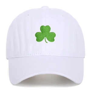 White washed cotton baseball cap featuring green clover embroidery and a curved brim