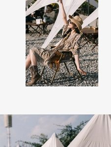 Detail of floral bohemian mini dress with v-neck and lantern sleeves in a sunny outdoor setting