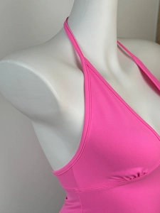 Close-up of bright pink fuchsia halter neck sports top with ribbed fabric texture