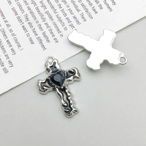 Silver cross pendant with black heart gemstone showing front and back metal detail
