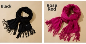 Detail of black and rose red cashmere scarves showing soft texture and fine fringe