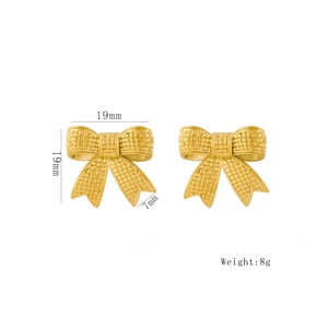 Golden bow-shaped stainless steel earrings with woven texture on a white background