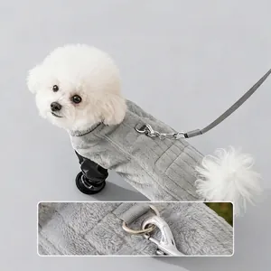 Grey winter dog vest with leash D-ring shown on a white Bichon Frise puppy