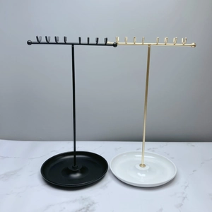 Dual T-shaped jewelry stands in black and gold metal with hooks and round tray base