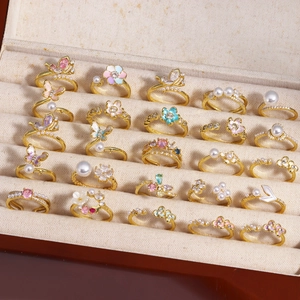 Macro detail of adjustable gold rings with butterfly motifs and colorful zircons