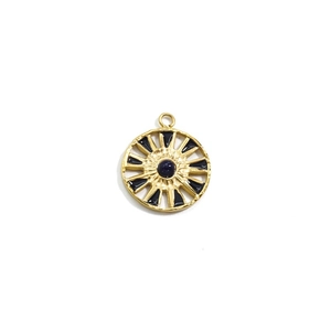 Macro detail of 14k gold plated sunflower pendant with blue stone and black enamel inlay