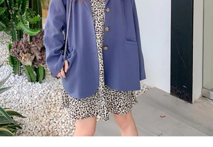 Close-up of blue longline blazer with leopard print mini dress in outdoor garden setting