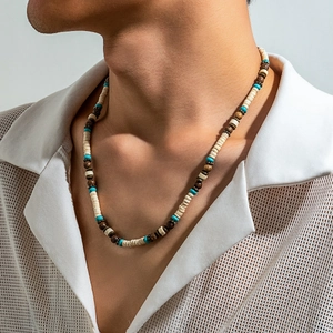Detail shot of bohemian surfer necklace with turquoise beads and wood discs on a male model
