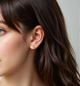 Close-up of a model wearing the gold fan-shaped shell stud earrings in S925 silver