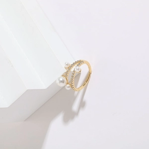 Close-up of 14K gold plated double wrap ring with white pearls and sparkling zircons