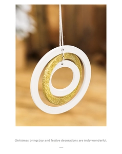 Detail of wooden Christmas star ornament with gold glitter nested ring and white cord