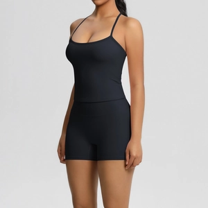 Detail of cross-back yoga tank top and high-waist shorts in matte black finish