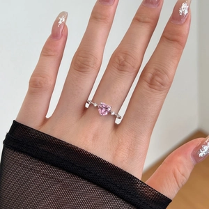 Macro shot of S925 silver ring featuring heart-shaped pink zircon and micro-set side stones