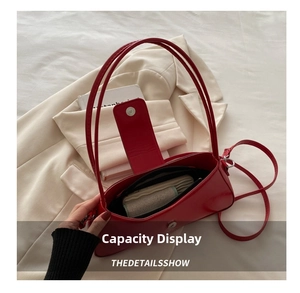 Detail view of the bright red leather baguette bag interior and silver magnetic buckle