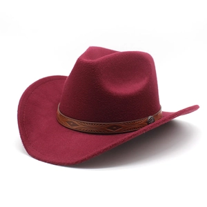 Detail of burgundy western cowboy hat with embossed brown leather band and metal buckle