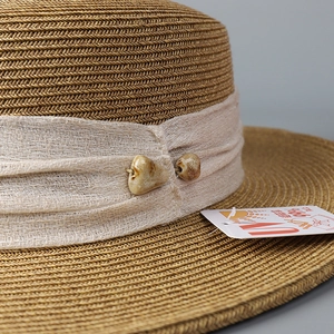 Brown woven flat-top straw hat for women with UV protection and decorative ceramic beads