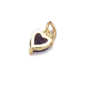 Detail shot of heart-shaped gold pendant with deep purple zircon and mounting loop