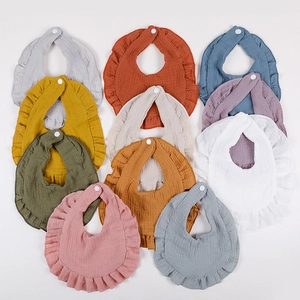 Ruffled cotton muslin baby bibs set in ten assorted colors with snap closure