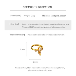 Detail view of gold fleur-de-lis ring with zircon inlay and product dimensions