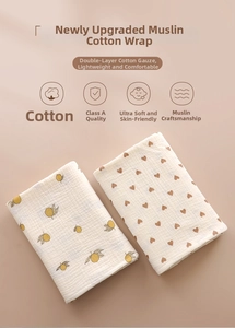 Close-up of double-layer cotton gauze baby swaddle with lemon and heart patterns