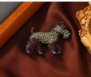 Detailed close-up of a vintage dog brooch with yellow and red gradient rhinestones