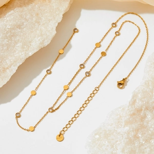 Detail of gold Y-necklace showing lobster clasp, adjustable chain and S.steel hallmark