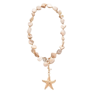 Ocean style necklace with beige shell beads and a golden starfish pendant on white background