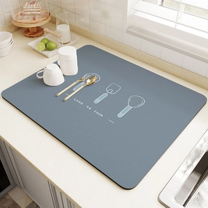 Macro detail of grey-blue kitchen drying mat with Love to Cook print and utensil graphics