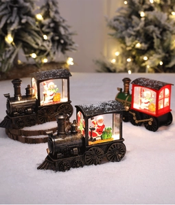 Detail of vintage Christmas train lanterns with warm LED lights and snowman miniatures