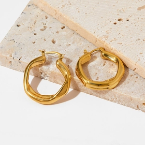Modern irregular twisted hoop earrings in polished gold finish for a minimalist style