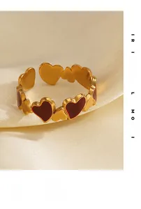 Detail of 18K gold-plated stainless steel heart ring with red enamel inlay texture